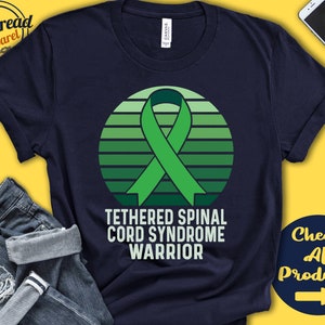 May include: A navy blue t-shirt featuring a green ribbon and a sunset design. The text "Tethered Spinal Cord Syndrome Warrior" is printed on the shirt.
