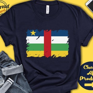 May include: A navy blue t-shirt with a distressed, faded design of the Central African Republic flag. The flag features a yellow star, red, white, green, and yellow stripes. The text "Check All Products" with a right arrow is in the bottom right corner.