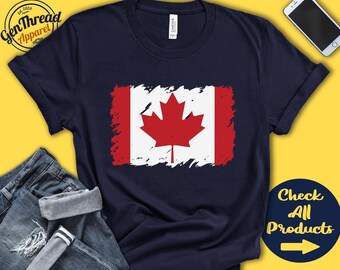 May include: A navy blue t-shirt with a distressed Canadian flag design. The flag features a red maple leaf on a white background with red stripes on the sides. The text "Check All Products" with a right arrow is in the bottom right corner.