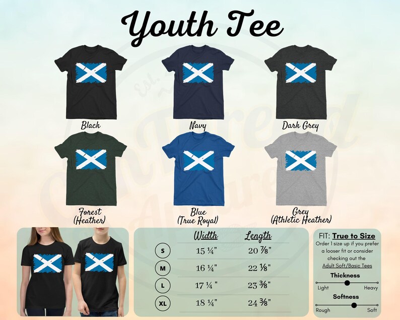 May include: Youth tee shirt with a Scottish flag design in various colors, including black, navy, dark grey, forest heather, blue, and grey. The size chart shows measurements in inches for width and length.