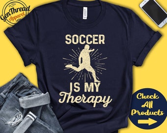 May include: Navy blue t-shirt with the text "SOCCER IS MY THERAPY" and a graphic of a soccer player kicking a ball. The shirt also has the "GenThread Apparel" logo. A button with the text "Check All Products" is visible.