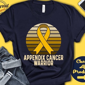 Puede incluir: Una camiseta azul marino con un diseño de cinta amarilla y el texto "Appendix Cancer Warrior".