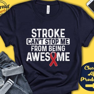 May include: A navy blue t-shirt with the text "STROKE CAN'T STOP ME FROM BEING AWESOME" in white with a red ribbon.