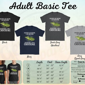 May include: A black, navy, dark grey, and grey t-shirt with a green crocodile graphic and the text "Crocodiles are awesome. I am awesome. Therefore I am a crocodile." The t-shirt is available in sizes S-3XL. A size chart is included with measurements in inches.