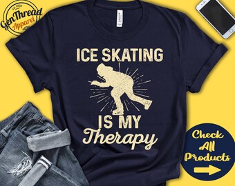 May include: A navy blue t-shirt with the text "Ice Skating is my Therapy" in white. A silhouette of a person ice skating is in the center of the shirt.