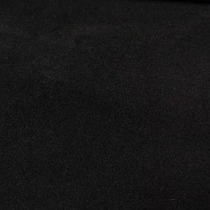 May include: A solid black fabric surface with a fine, uniform, and slightly textured matte finish. The material appears dense and opaque, covering the entire frame with a consistent dark tone and a subtle, granular visual quality.