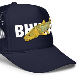 May include: Navy blue trucker hat with white text and a yellow fish illustration. The hat features a mesh back and a curved brim. The text on the hat appears to read "BH" followed by other letters.