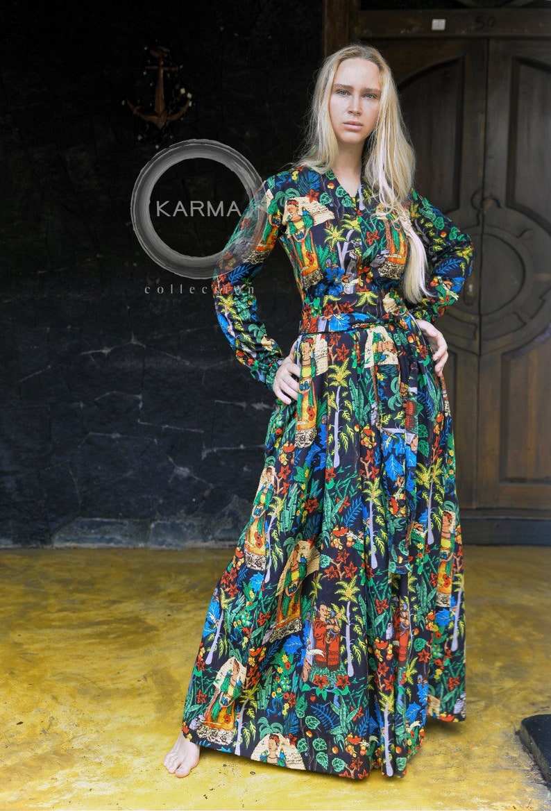 May include: A long-sleeved maxi dress with a black background and a colorful floral print. The dress has a button-up front and a belt at the waist. The print features a variety of flowers, leaves, and birds. The dress is made of a lightweight fabric and is perfect for warm weather.