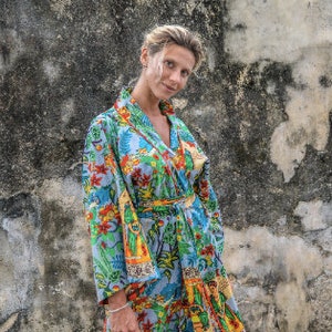 May include: A blue and green floral print kimono robe with a long sleeve and a tie belt.