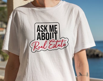 May include: White t-shirt with black text that reads "Ask Me About Real Estate" in a red cloud-shaped graphic.