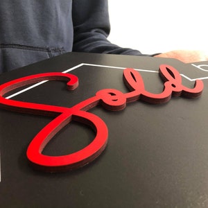 May include: A red "Sold" sign with a white border on a black background.