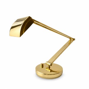 May include: A gold-colored desk lamp with an adjustable arm and a round base. The lamp has a rectangular shade with horizontal slits and a small on/off switch. The lamp is made of metal and has a shiny finish.