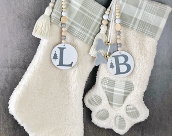 Christmas Paw stockings with personalized wooden bead letter tags.Cream white Sherpa stocking for dog or cat pets.Unique stockings for gifts