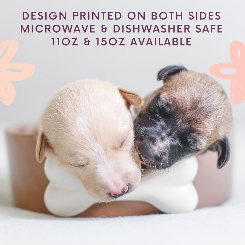 May include: Two small puppies sleeping in a brown and white ceramic dog bowl. The bowl has a bone-shaped handle. The puppies are cream and black and white. The text on the image reads "Design printed on both sides. Microwave & Dishwasher safe. 11oz & 15oz available."