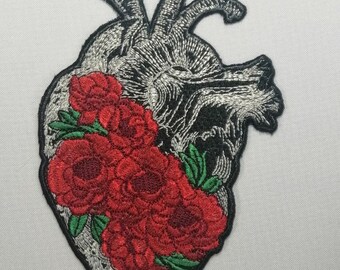 May include: An embroidered iron-on patch featuring a detailed anatomical heart with red roses and green leaves.
