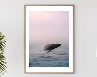 May include: A white dining table with a wooden top and white chairs. A framed photograph of a whale jumping out of the water is hanging on the wall behind the table. A potted palm tree is in the corner of the room.
