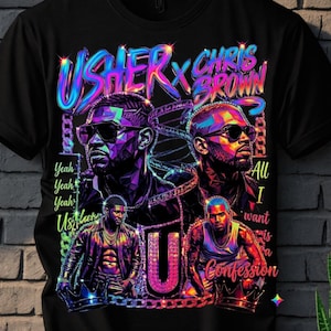 K&ouml;nnte beinhalten: Ein schwarzes T-Shirt mit einem lebendigen, mehrfarbigen Grafikdruck von Usher und Chris Brown. Das Design enth&auml;lt den Text "USHER x CHRIS BROWN", "Yeah Yeah Yeah", "All I want is a Confession" und einen gro&szlig;en Buchstaben "U", der von Ketten umgeben ist.