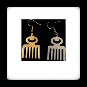 May include: A pair of earrings featuring a gold and silver comb design. The comb is a traditional African symbol of beauty and prosperity.