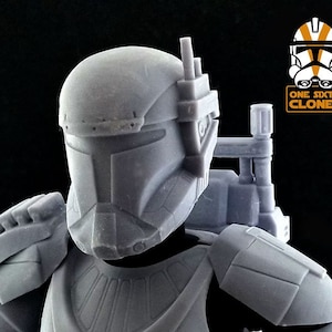 May include: A gray plastic action figure of a Star Wars clone trooper with a detailed helmet and a backpack. The figure is wearing a gray and black uniform. The figure is part of a collection of Star Wars action figures.