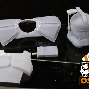 May include: A set of white plastic 3D printed Star Wars clone trooper armor pieces. The set includes a helmet, chest plate, shoulder pads, and a utility belt.