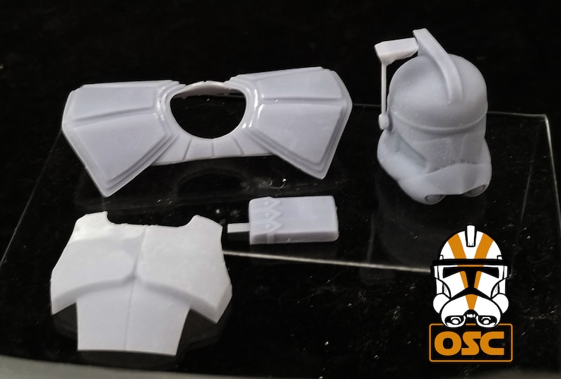 May include: A set of white plastic 3D printed Star Wars clone trooper armor pieces. The set includes a helmet, chest plate, shoulder pads, and a utility belt.