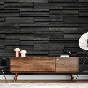 Puede incluir: Una consola de medios de madera oscura con dos cajones y una puerta. La consola est&aacute; sentada en un piso de madera frente a una pared de ladrillo negro. Hay tres jarrones rosas en la parte superior de la consola. Una silla negra est&aacute; a la izquierda de la consola y una l&aacute;mpara de pie negra con una pantalla blanca est&aacute; a la derecha.