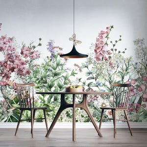 May include: A wall mural featuring a watercolor illustration of pink and purple wildflowers, green foliage, and butterflies. A round wooden dining table with two matching spindle-back chairs is positioned in front of the floral wall design.
