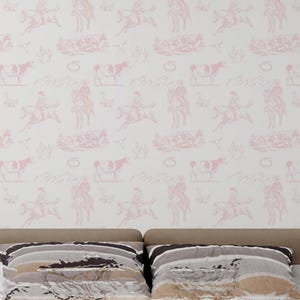 May include: Wallpaper featuring a repeating pattern of light pink line drawings on a white background. The illustrations depict figures riding horses, cattle, and various landscape elements in a continuous, monochromatic toile-style design.