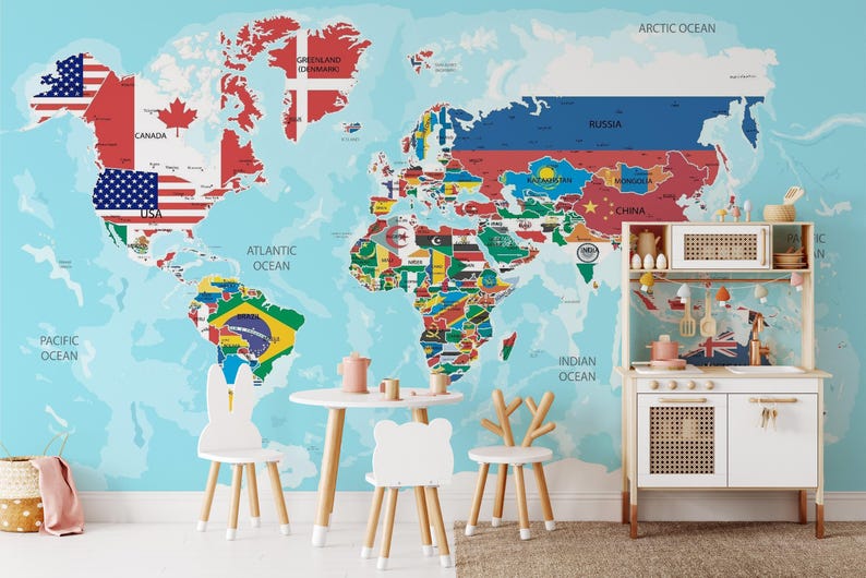 A living room wall decorated with a large, peel and stick world map wallpaper that includes the flags of the world.