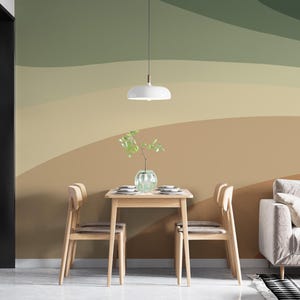May include: A wall mural featuring large, sweeping horizontal bands of color in shades of sage green, olive, beige, and tan. The design creates a layered, abstract landscape effect across the wall, providing a neutral backdrop for the room.