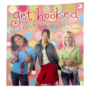 May include: A book cover with a pink background and colorful polka dots. The title is "get hooked" in red and white letters. The subtitle is "Simple Steps to Crochet Cool Stuff" in black letters. The author's name is "Kim Werker" in black letters.