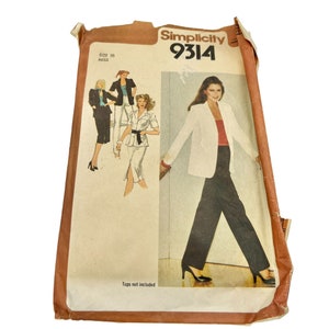 May include: Simplicity sewing pattern number 9314 for a women's blazer and pants. The pattern is for sizes 10-12 and is for misses. The pattern shows a woman wearing a white blazer and black pants. The text "Tops not included" is printed on the pattern.