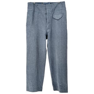 May include: A pair of gray wool trousers with a high waist and button closure. The pants have a single pocket on the right side and a straight leg design. The fabric has a textured appearance.