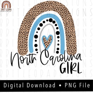 May include: A rainbow design with a leopard print pattern, a blue and gray heart, and black dots. The text "North Carolina Girl" is written below the rainbow.