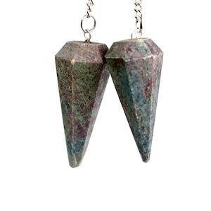 May include: Two silver chains with dark green and red gemstone pendulums. The pendulums are pointed and have a faceted design.