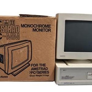 May include: An off-white Amstrad PC-MM monochrome monitor and a matching computer unit with a floppy disk drive, accompanied by a brown cardboard box labeled Amstrad PC-MM Monochrome Monitor for the Amstrad PC Series, Gross Weight 9.0 kgs.
