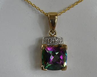 May include: A gold chain necklace with a pendant featuring a large, square-shaped, iridescent gemstone surrounded by a halo of smaller, clear gemstones.