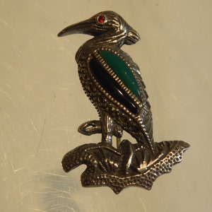Silver Agate and Onyx Bird brooch set with garnet eye.