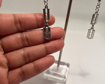 Silver tone dangle razor blade earrings