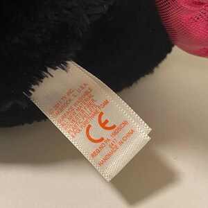 May include: A black and pink plush toy with a white tag that reads "2017 TY INC. SOAKBROOK, IL. U.S.A SURFACE WASHABLE CE REG.NO PA 15826(CN) 0417 HANDMADE IN CHINA"