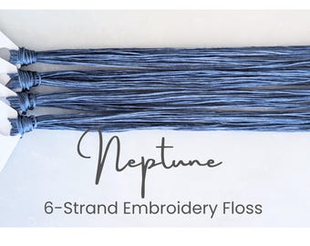 May include: Six bundles of blue Neptune 6-strand embroidery floss. The floss is neatly arranged, with the ends tied together. The word "Neptune" is written in cursive, with the text "6-Strand Embroidery Floss" below it.