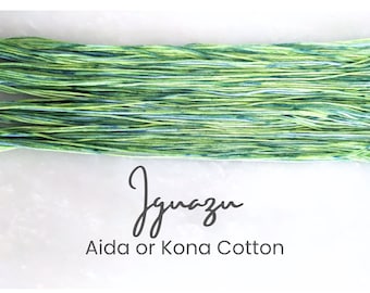 Op de afbeelding: Een close-up van een bol groene en blauwe garen met de tekst "Ignazu Aida of Kona Cotton".