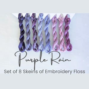 May include: Set of eight skeins of embroidery floss in shades of purple, labeled "Purple Rain".