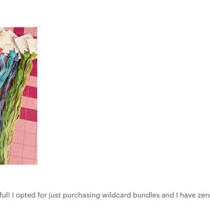 May include: A close-up of a collection of colorful embroidery floss spools. The floss is arranged in a rainbow pattern and is ready for use in a craft project.