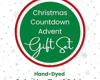 Op de afbeelding: Een cirkelvormige afbeelding met een rood en groen ontwerp. De tekst luidt "Christmas Countdown Advent Gift Set" in het wit. Daaronder staat de tekst "Hand-Dyed Embroidery Floss & Fabric" in het groen.