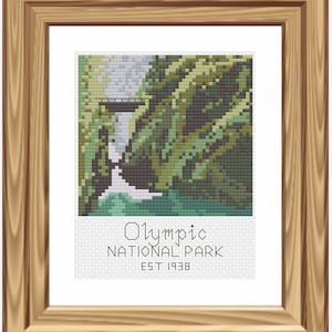 May include: A cross-stitch pattern of a waterfall in Olympic National Park, Washington. The image features a bridge over the waterfall and lush green foliage. The text "Olympic National Park Est 1938" is below the image.