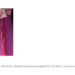 May include: Five skeins of embroidery floss in various colors, including teal, light blue, lavender, and pink. The floss is arranged in a curved shape on a purple surface.  Beautiful!!! Can't wait to stitch with them. Already figured out projects for 3 of them. I so can't wait!!!! I will be ordering more. I love the wildcards!!!!