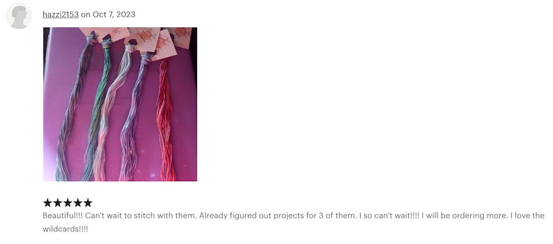 May include: Five skeins of embroidery floss in various colors, including teal, light blue, lavender, and pink. The floss is arranged in a curved shape on a purple surface.  Beautiful!!! Can't wait to stitch with them. Already figured out projects for 3 of them. I so can't wait!!!! I will be ordering more. I love the wildcards!!!!