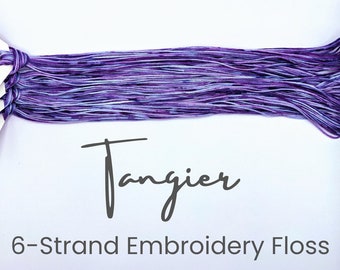 May include: Purple and blue 6-strand embroidery floss skeins labeled "Tangier".