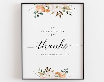 May include: A printable art print featuring a floral design in shades of peach, white, and green. The text reads "In everything give thanks 1 Thessalonians 5:18".